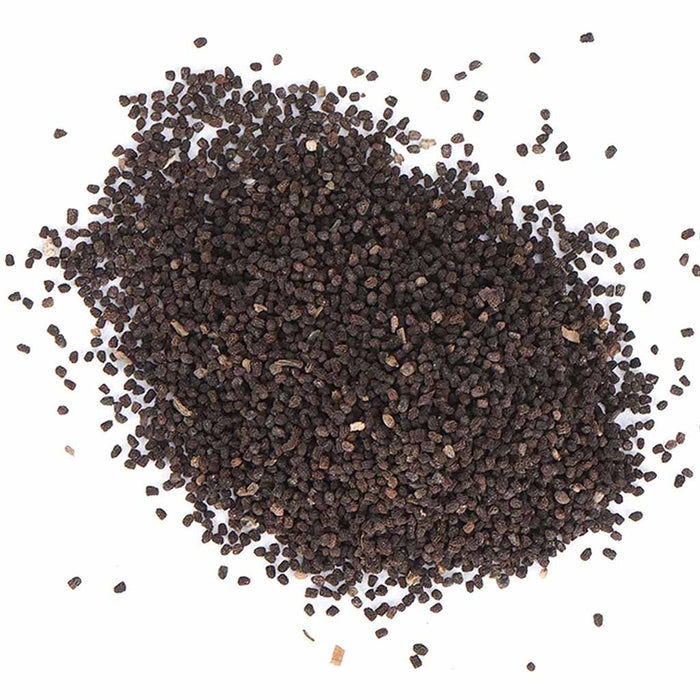Heap of dark brown seeds on a white background