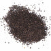 Heap of dark brown seeds on a white background