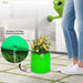Person-watering-a-plant in a green fabric pot with excellent drainage shown.