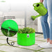 watering a green plant in a grow bag with a close-up of excellent drainage from the drainage hole.
