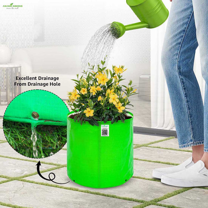 Person watering a plant in a green fabric pot with excellent drainage highlighted.