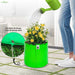 Person watering a plant in a green fabric pot with excellent drainage highlighted.