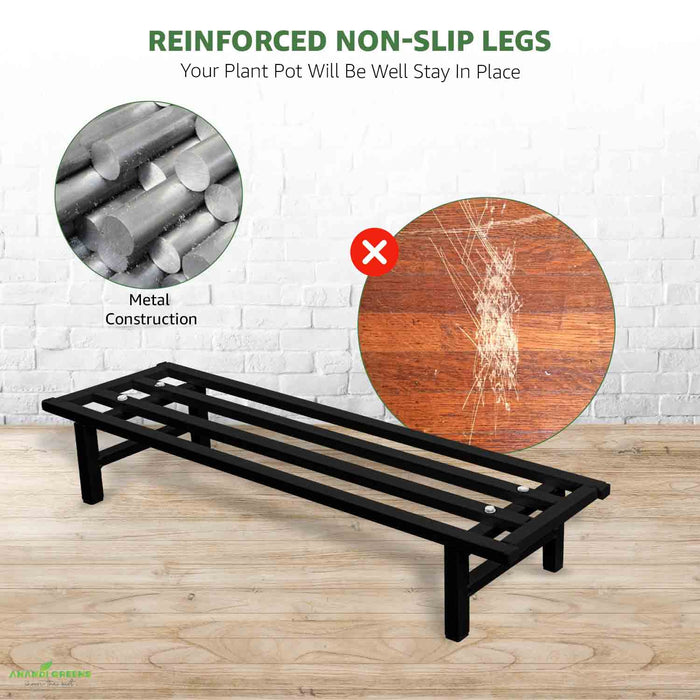 Black metal plant stand with reinforced non-slip legs on a wooden floor, showing metal construction and durability.
