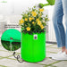 Green inflatable pot with yellow flowers being watered, highlighting excellent drainage.
