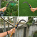 hand using garden sickle for cutting plants and grass in home garden
