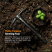 Multi-purpose farming tool on soil with a small plant, suitable for digging and breaking hard soil